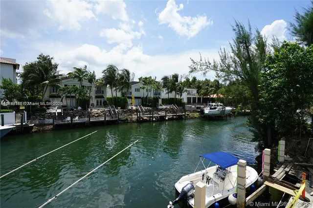 a view of a lake with boats and trees in the background