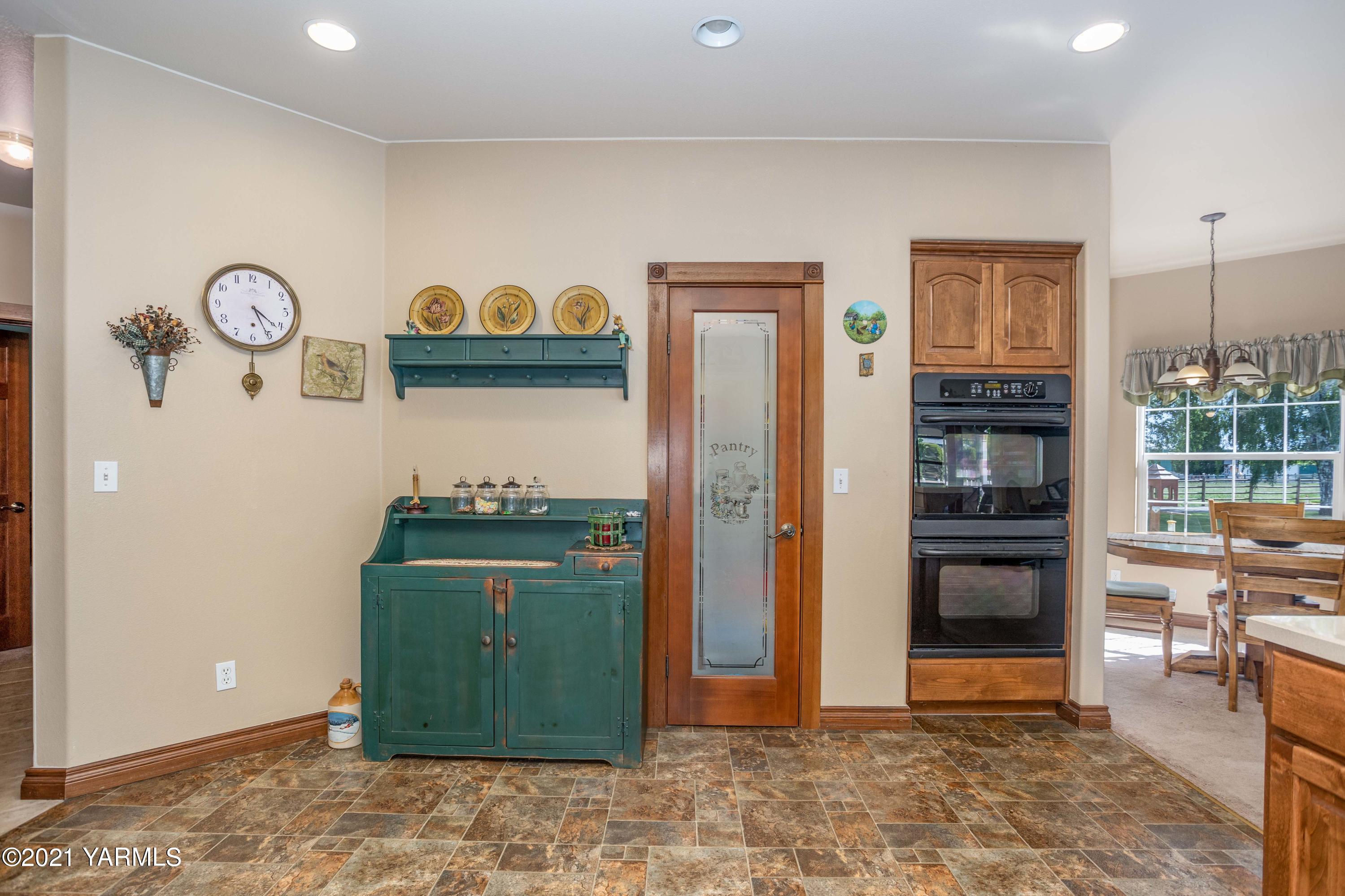 3131 Scoon Road Sunnyside, WA 98944 - Photo 10 of 33 a view of a kitchen with fridge and wooden floor
