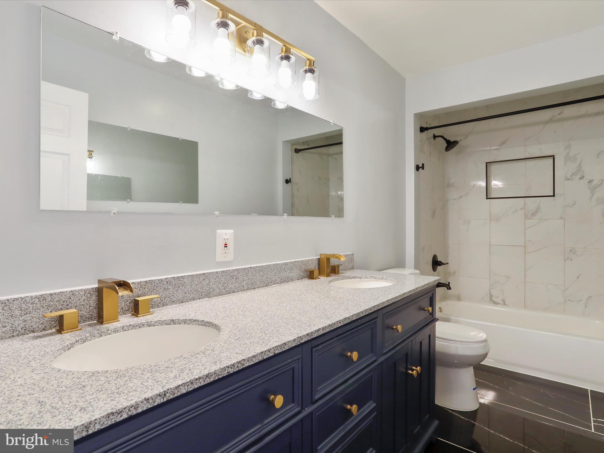8175 Stone Bridge Road Greencastle, PA 17225 - Photo 18 of 44 a bathroom with a granite countertop sink a toilet and a bathtub