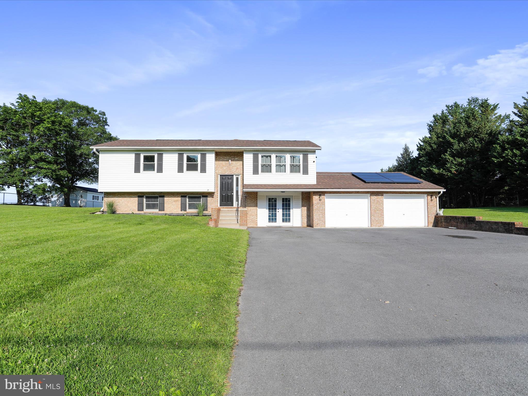 8175 Stone Bridge Road Greencastle, PA 17225 - Photo 3 of 44 a front view of a house with a yard and trees
