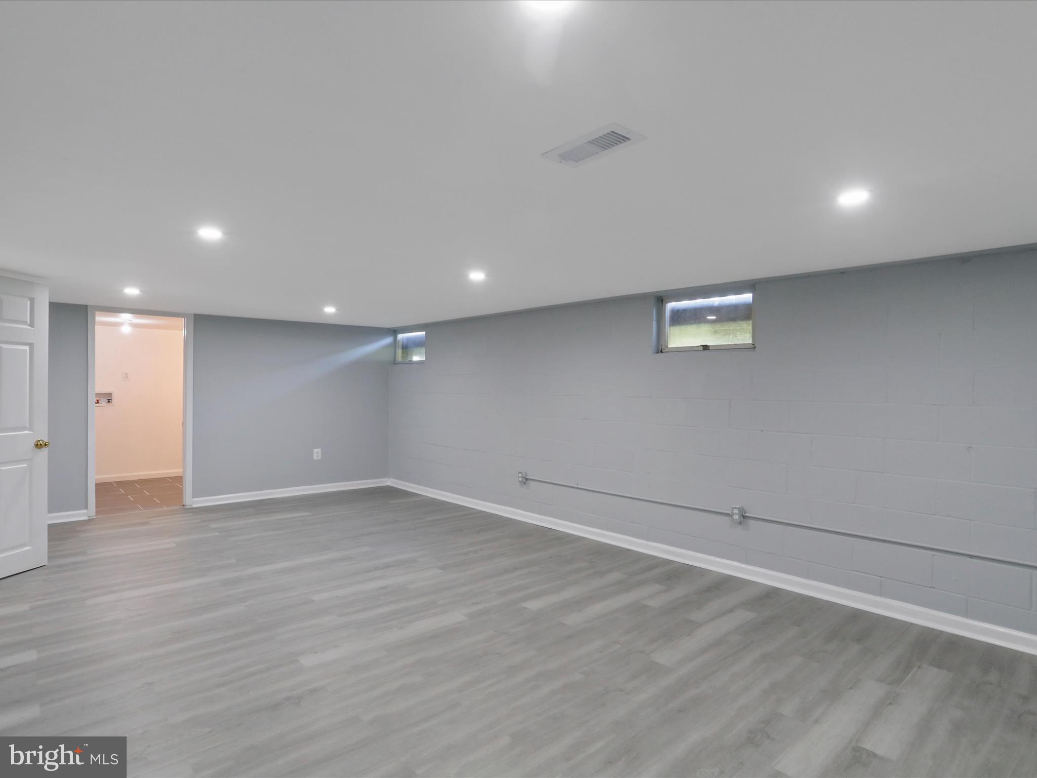 8175 Stone Bridge Road Greencastle, PA 17225 - Photo 33 of 44 an empty room with wooden floor and windows