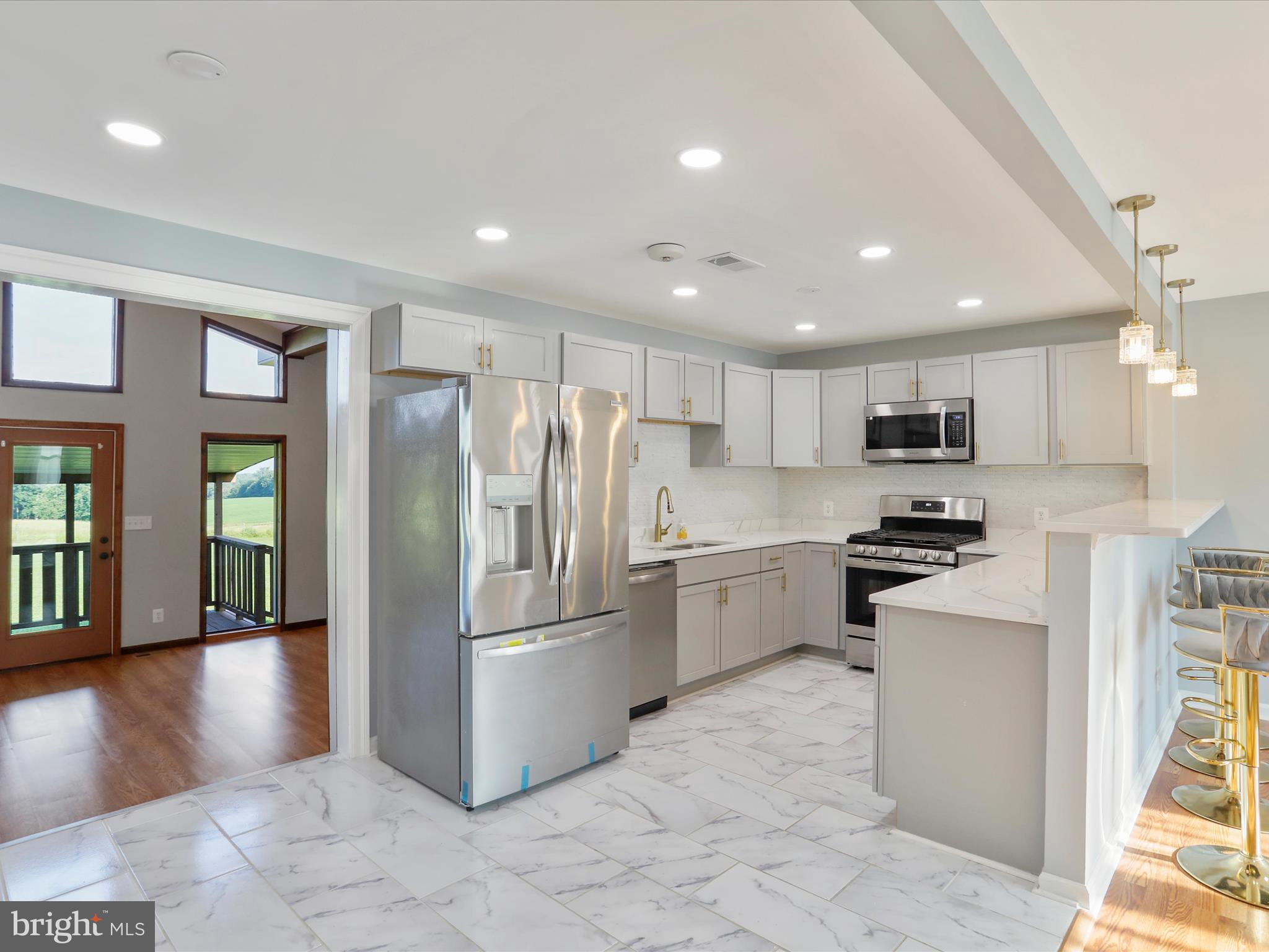 8175 Stone Bridge Road Greencastle, PA 17225 - Photo 5 of 44 a kitchen with stainless steel appliances granite countertop a refrigerator sink and stove