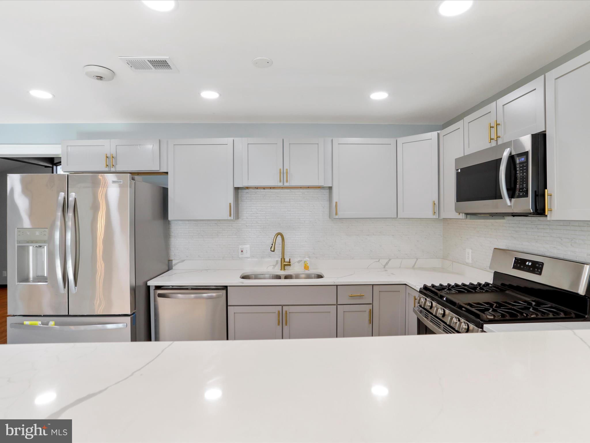 8175 Stone Bridge Road Greencastle, PA 17225 - Photo 8 of 44 a kitchen with stainless steel appliances a sink a stove a microwave a refrigerator a counter top space and cabinets