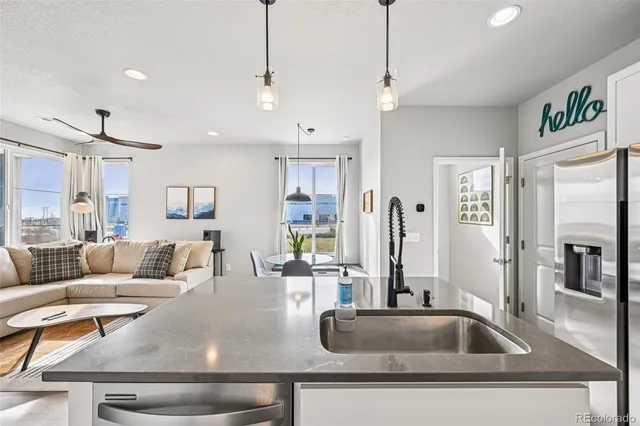 a living room with kitchen island furniture and a chandelier
