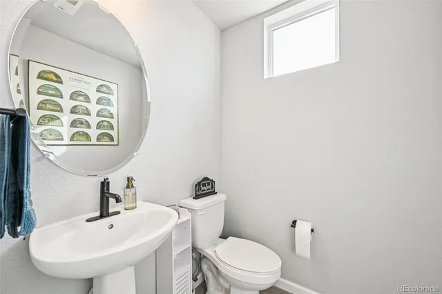 a white toilet sitting next to a bathroom sink