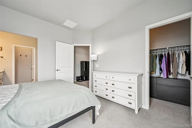 a bedroom with a bed and a mirror