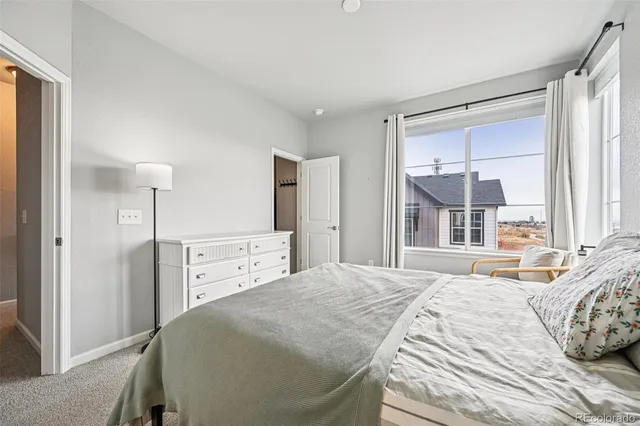 a spacious bedroom with a bed and a large mirror