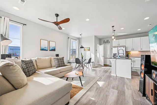 a living room with furniture and kitchen view