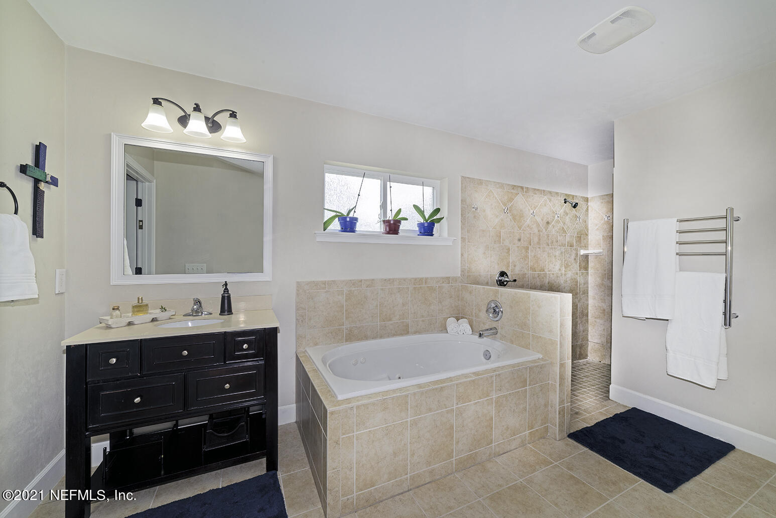 12052 Southwest 2nd Road Gainesville, FL 32607 - Photo 18 of 31 a bathroom with a tub sink double vanity and a mirror