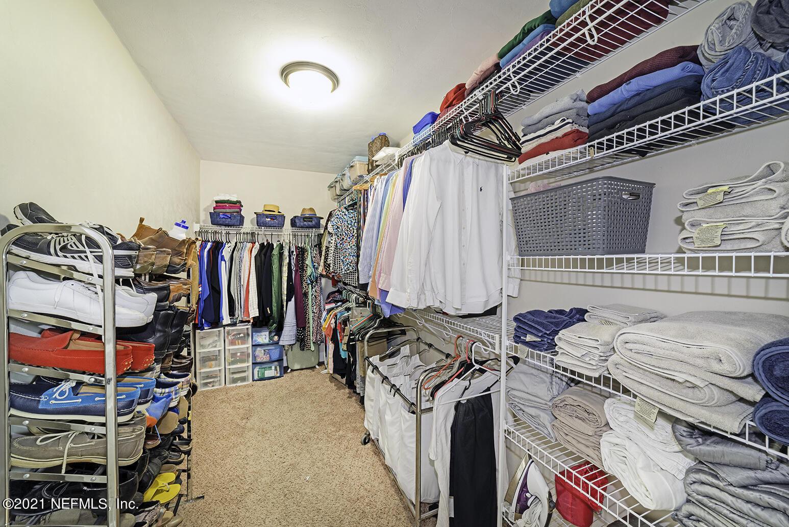 12052 Southwest 2nd Road Gainesville, FL 32607 - Photo 19 of 31 a view of walk in closet with clothes and shoes
