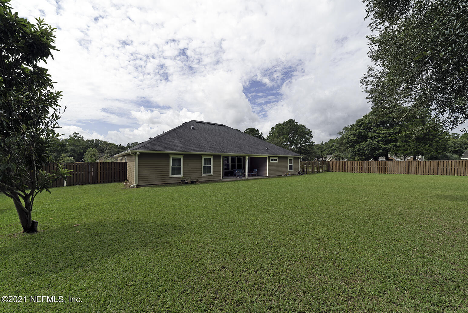 12052 Southwest 2nd Road Gainesville, FL 32607 - Photo 27 of 31 a view of a house next to a yard with big trees