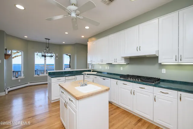a view of empty room with wooden floor and fireplace