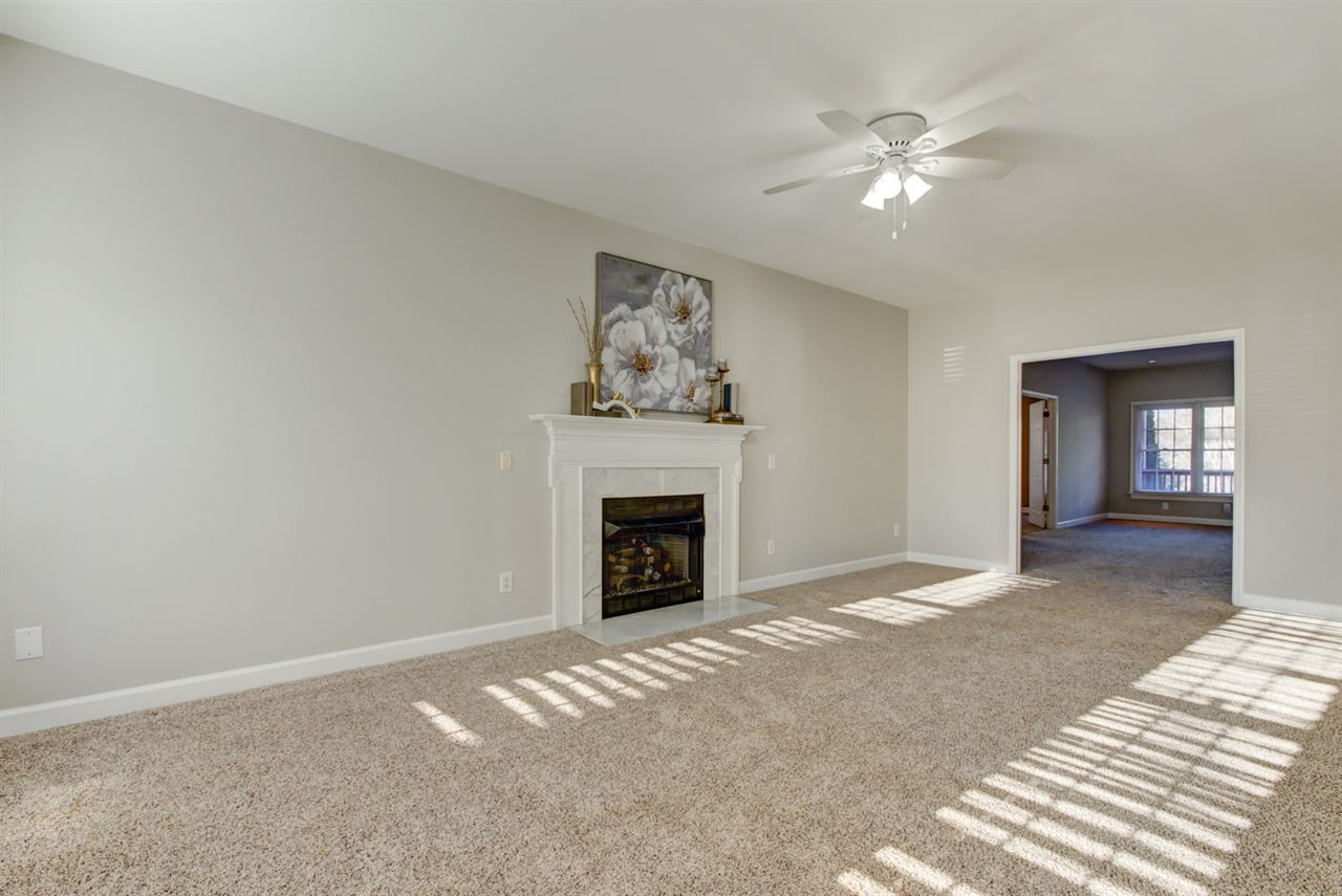 7220 Ridgeline Drive Raleigh, NC 27613 - Photo 12 of 16 Bright living room with cozy fire place and open to family room. Living Room