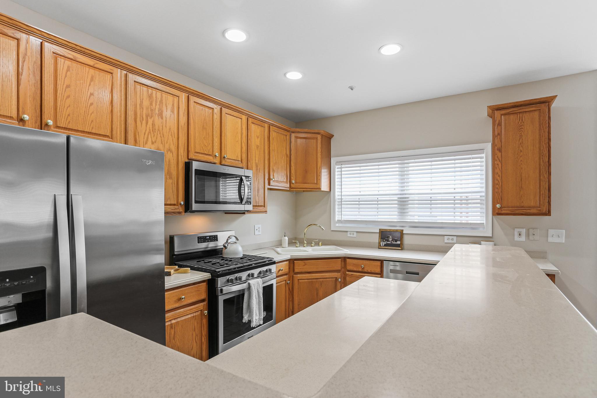 10232 Rutland Round Road, Unit 24 Columbia, MD 21044 - Photo 9 of 31 a kitchen with stainless steel appliances granite countertop a refrigerator a sink a stove and cabinets