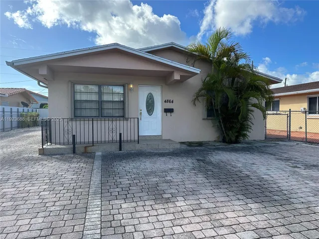 a view of a house with a yard and plants