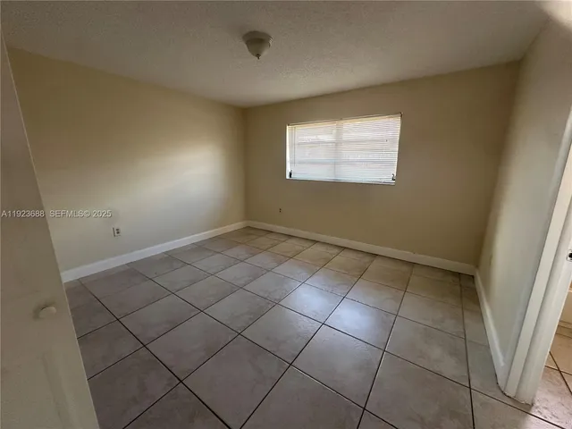a view of an empty room and a window