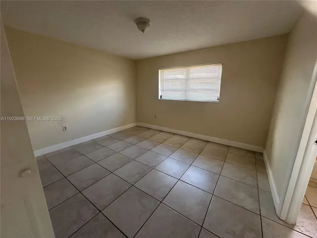 a view of an empty room and a window