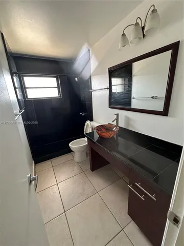 a lobby with furniture and a mirror