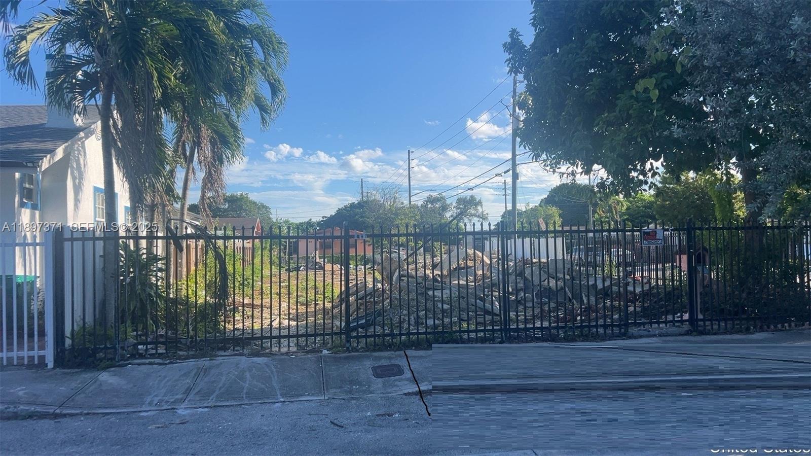 2052 Northwest 27th Street Miami, FL 33142 - Photo 3 of 14 a view of a wrought iron fences in front of yard