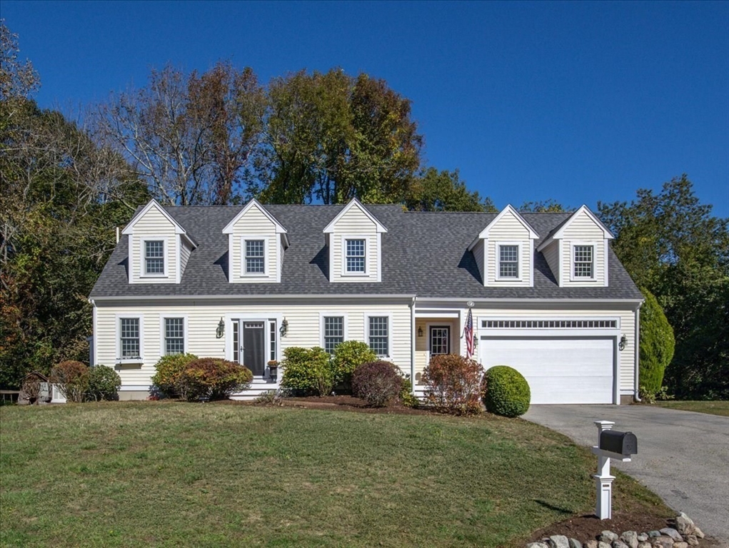 a view of a white house with a big yard and large trees