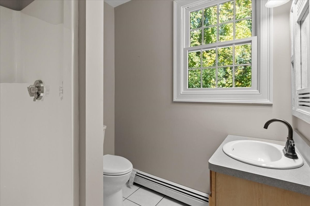 8 Trudys Lane Scituate, MA 02066 - Photo 20 of 41 a bathroom with a sink a toilet and a window