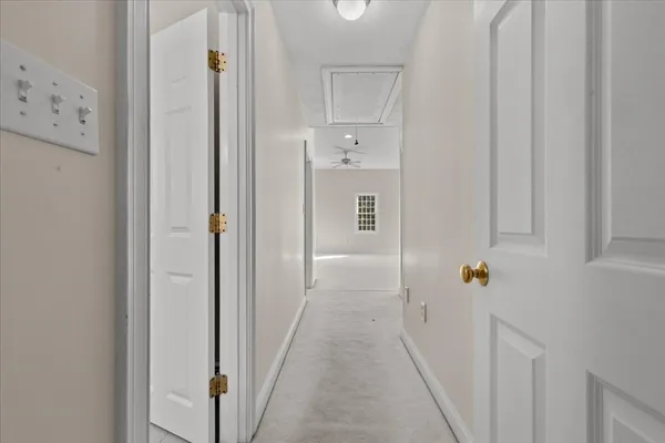 a view of a hallway with closet and front door