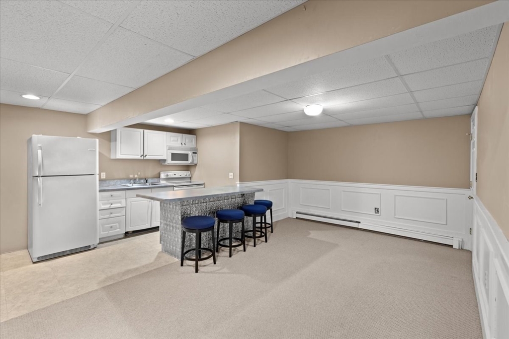 8 Trudys Lane Scituate, MA 02066 - Photo 32 of 41 a kitchen with white cabinets and white appliances