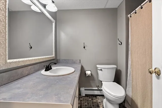 a white toilet sitting next to a bathroom sink