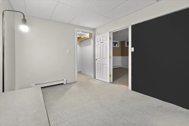 an empty room with closet and mirror