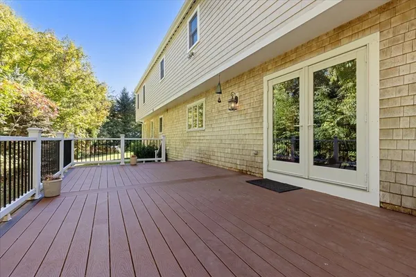 a view of backyard with deck and wooden floor