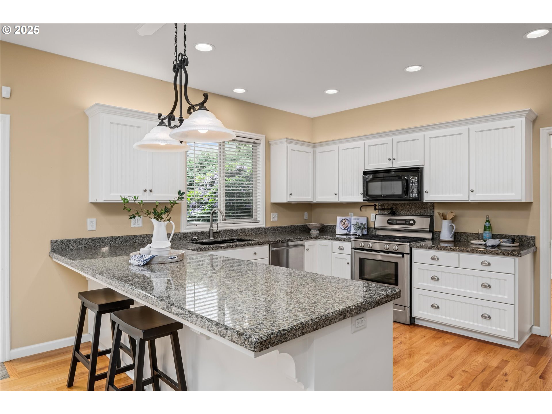 2053 Lakeview Drive Eugene, OR 97408 - Photo 12 of 45 a kitchen with stainless steel appliances granite countertop a stove a sink dishwasher a microwave oven with cabinets and wooden floor