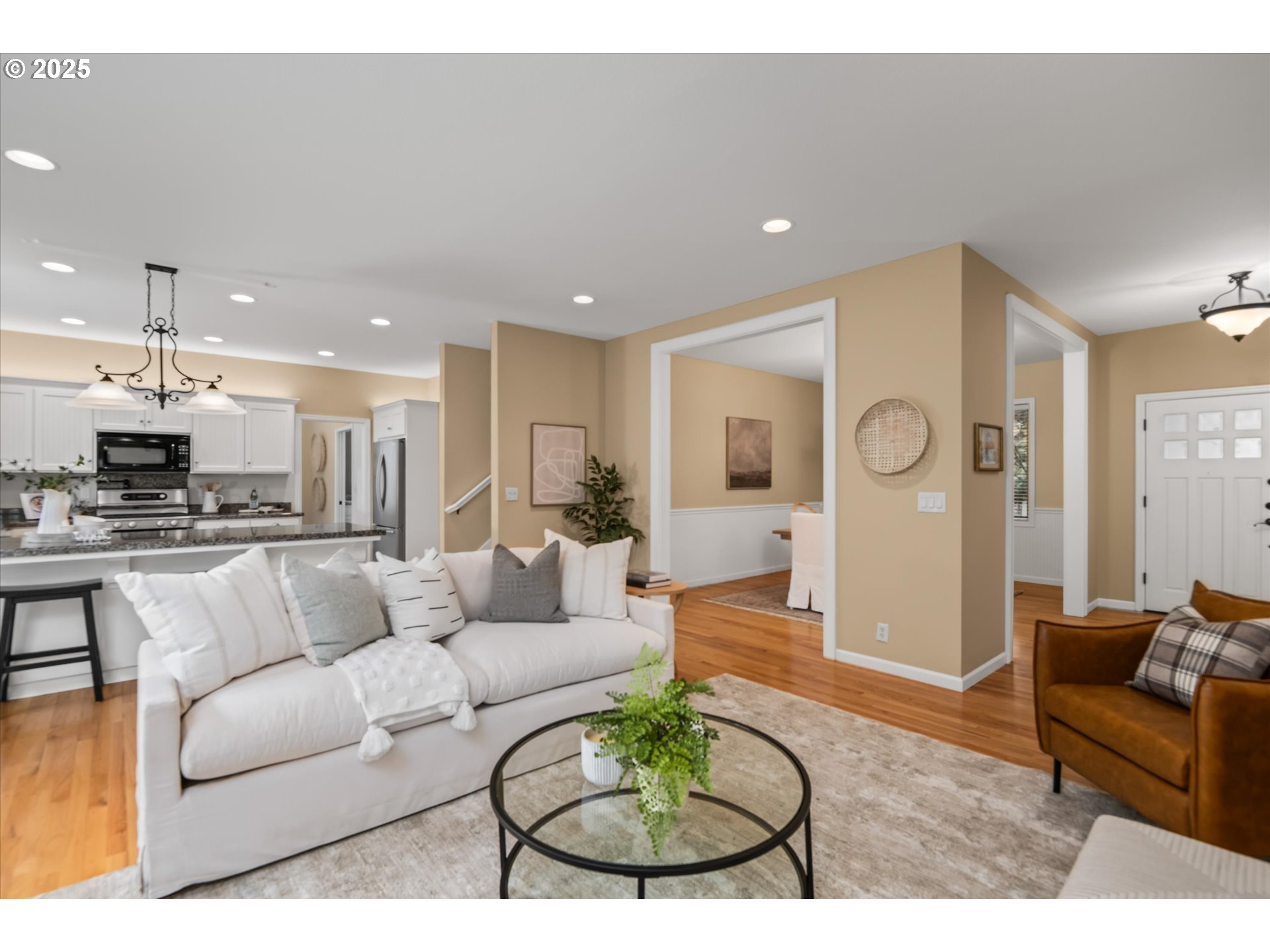 2053 Lakeview Drive Eugene, OR 97408 - Photo 10 of 45 a living room with furniture a rug kitchen view and a chandelier