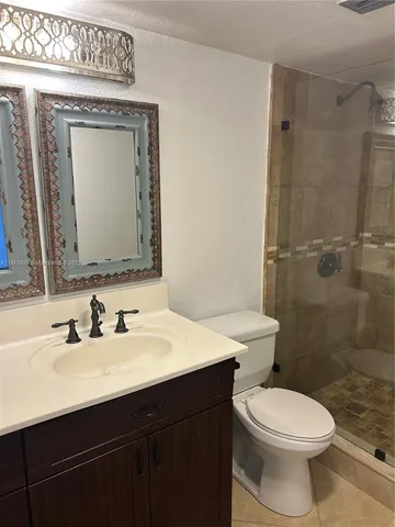 a view of a hallway with wooden floor and a chair