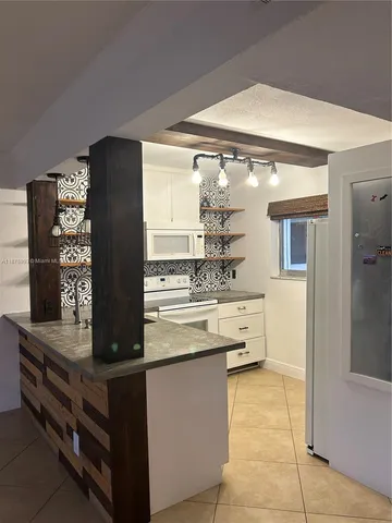 a kitchen with stainless steel appliances granite countertop a stove and a refrigerator