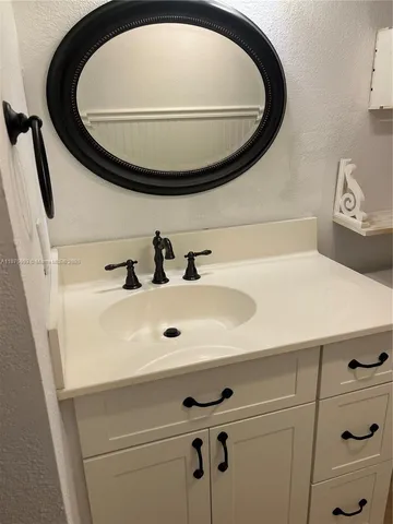 a bathroom with a sink and mirror