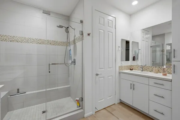 a bathroom with a double vanity sink toilet and shower