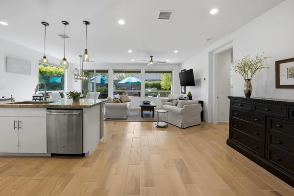 a living room with furniture and a wooden floor