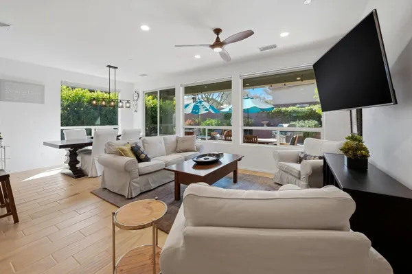 a living room with furniture tv and a large window