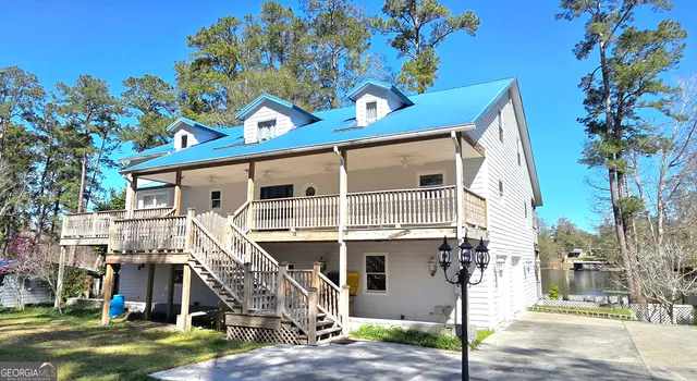 a front view of a house with a tree