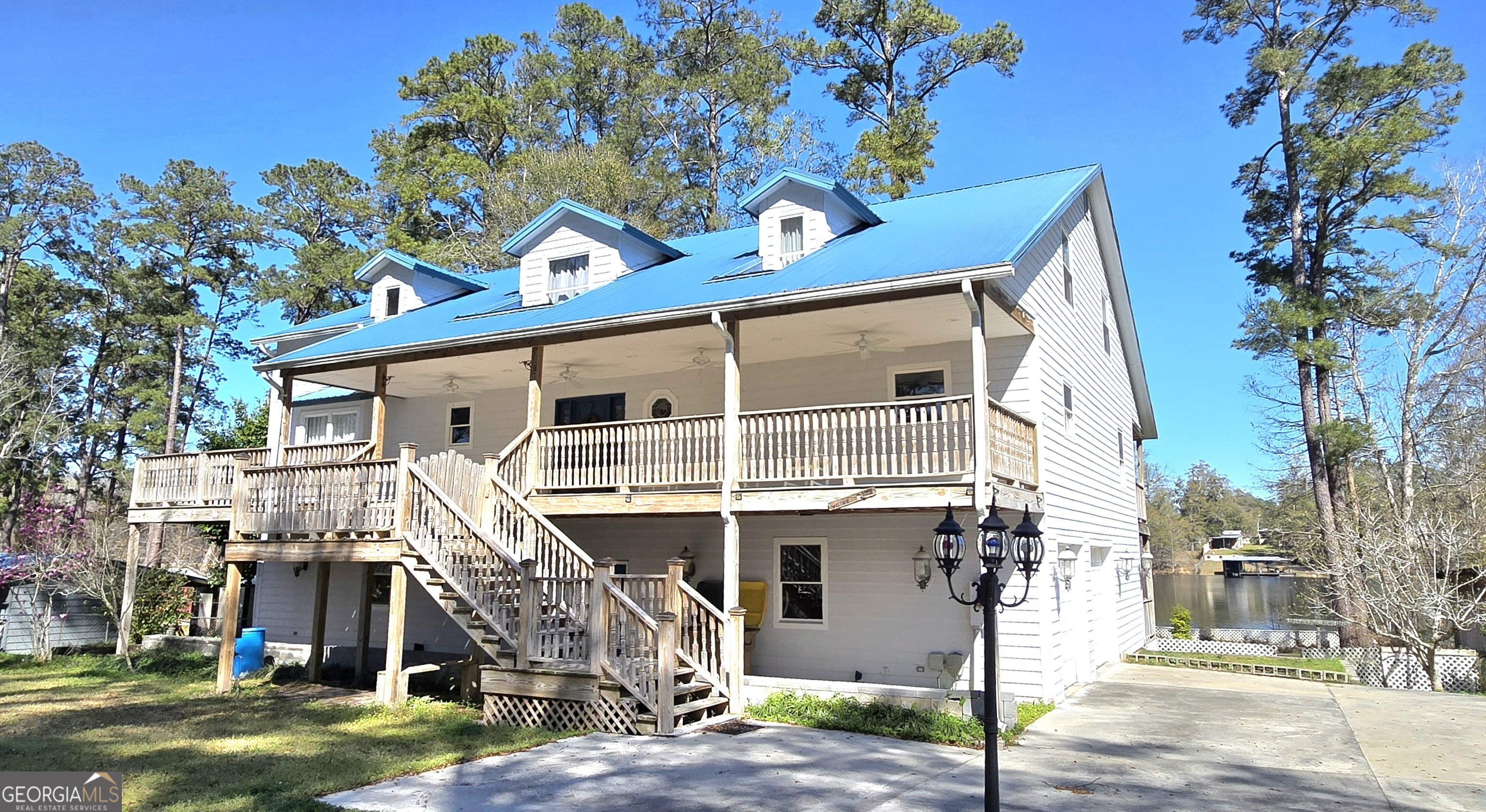 a front view of a house with a tree
