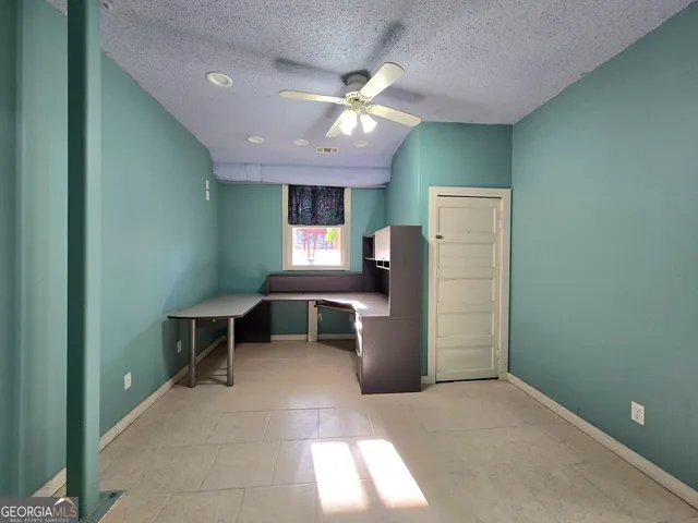 a room with lots of wooden furniture and a chandelier