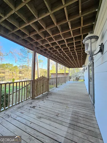 a view of a backyard with couches plants and large tree