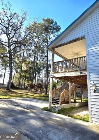 a view of a yard with wooden fence and bench
