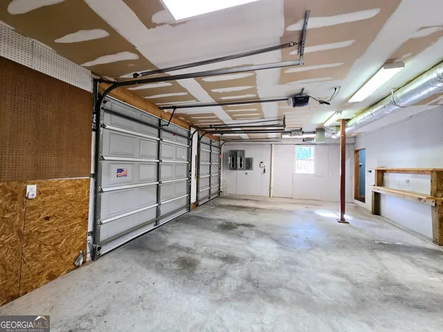 a view of a room with lots of wooden furniture and a chandelier