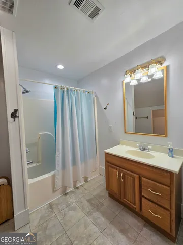 a spacious bathroom with a double vanity sink and a mirror