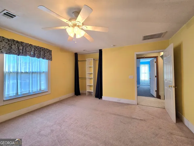 a view of a patio with table and chairs with wooden floor and floor to ceiling window