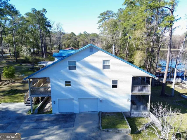 a view of a lake with boats and trees in the background