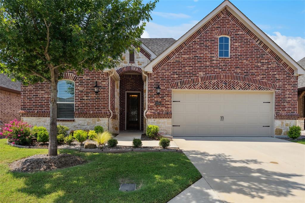 2104 Ladera Way, Unit 2104 Mansfield, TX 76063 - Photo 1 of 27 a front view of a house with a garden and plants