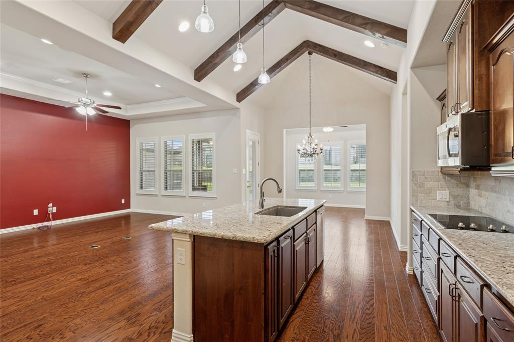 2104 Ladera Way, Unit 2104 Mansfield, TX 76063 - Photo 12 of 27 a kitchen with granite countertop a stove a sink and a refrigerator