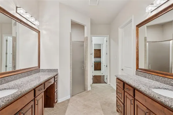 a spacious bathroom with a granite countertop sink and a mirror